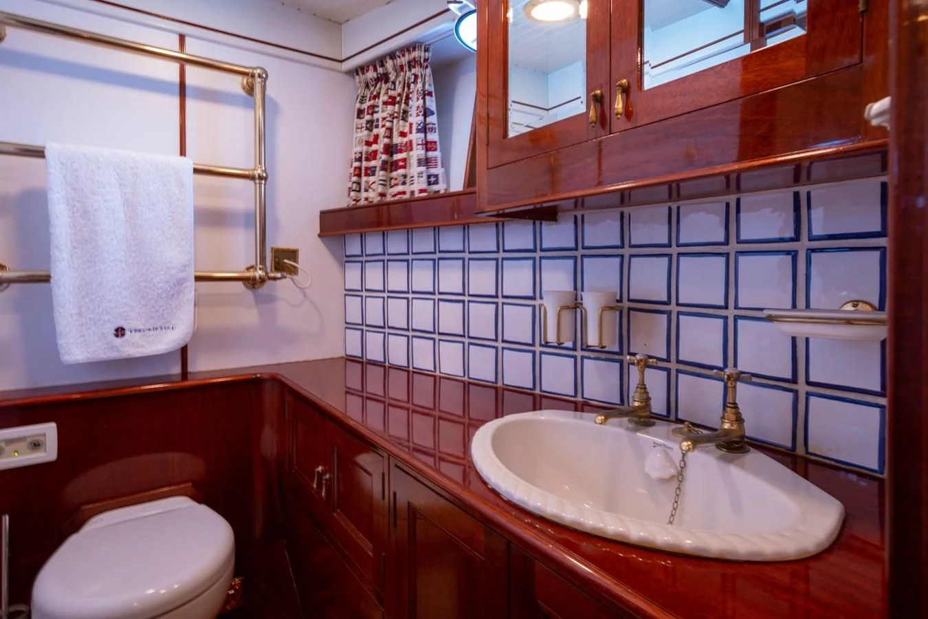 a bathroom with a sink and a toilet aboard FREDRIKSTAD Yacht for Sale
