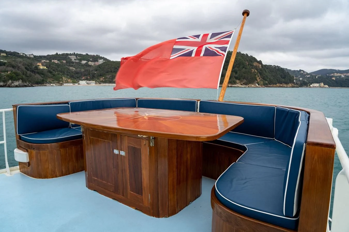 a table with a flag on it aboard FREDRIKSTAD Yacht for Sale