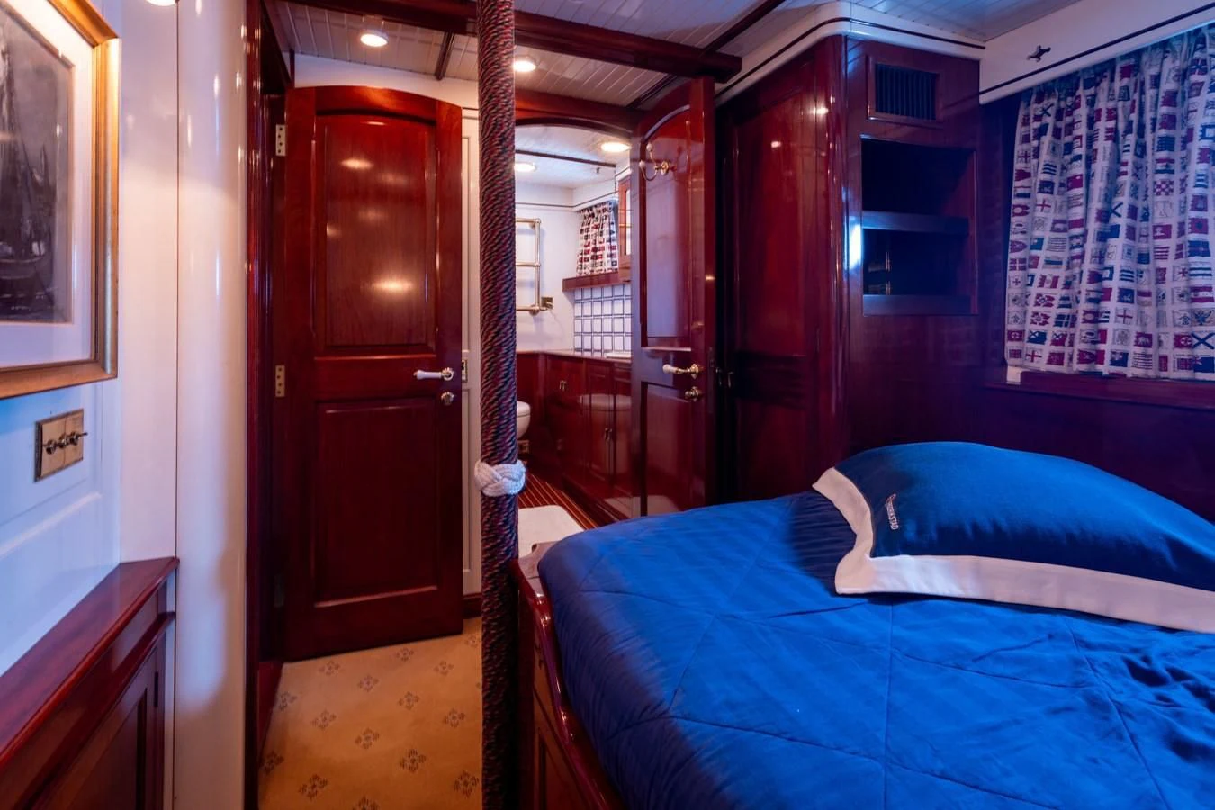 a bedroom with a bed and a closet aboard FREDRIKSTAD Yacht for Sale