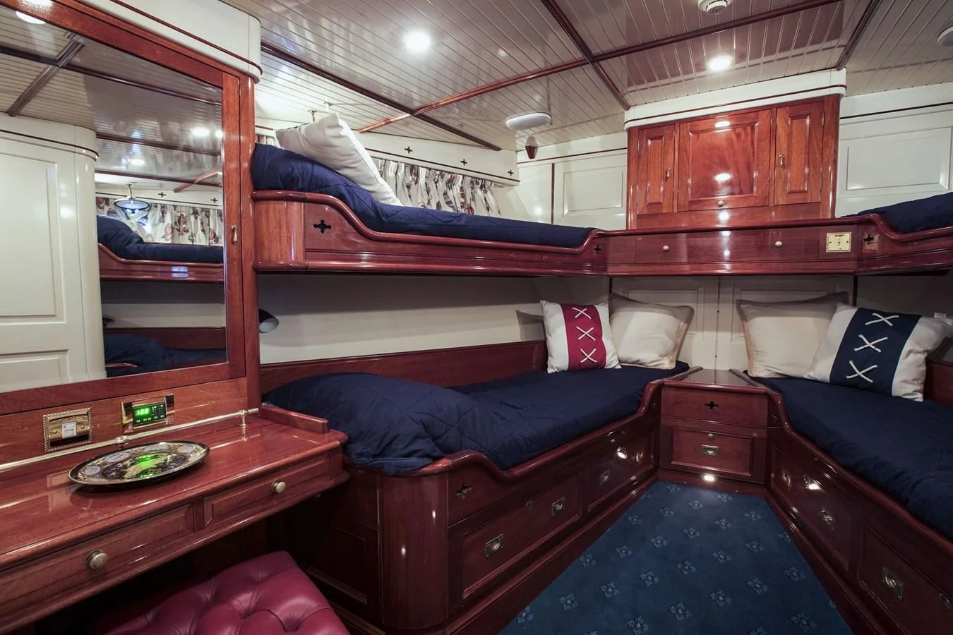 a cabin with a bed and a dresser aboard FREDRIKSTAD Yacht for Sale