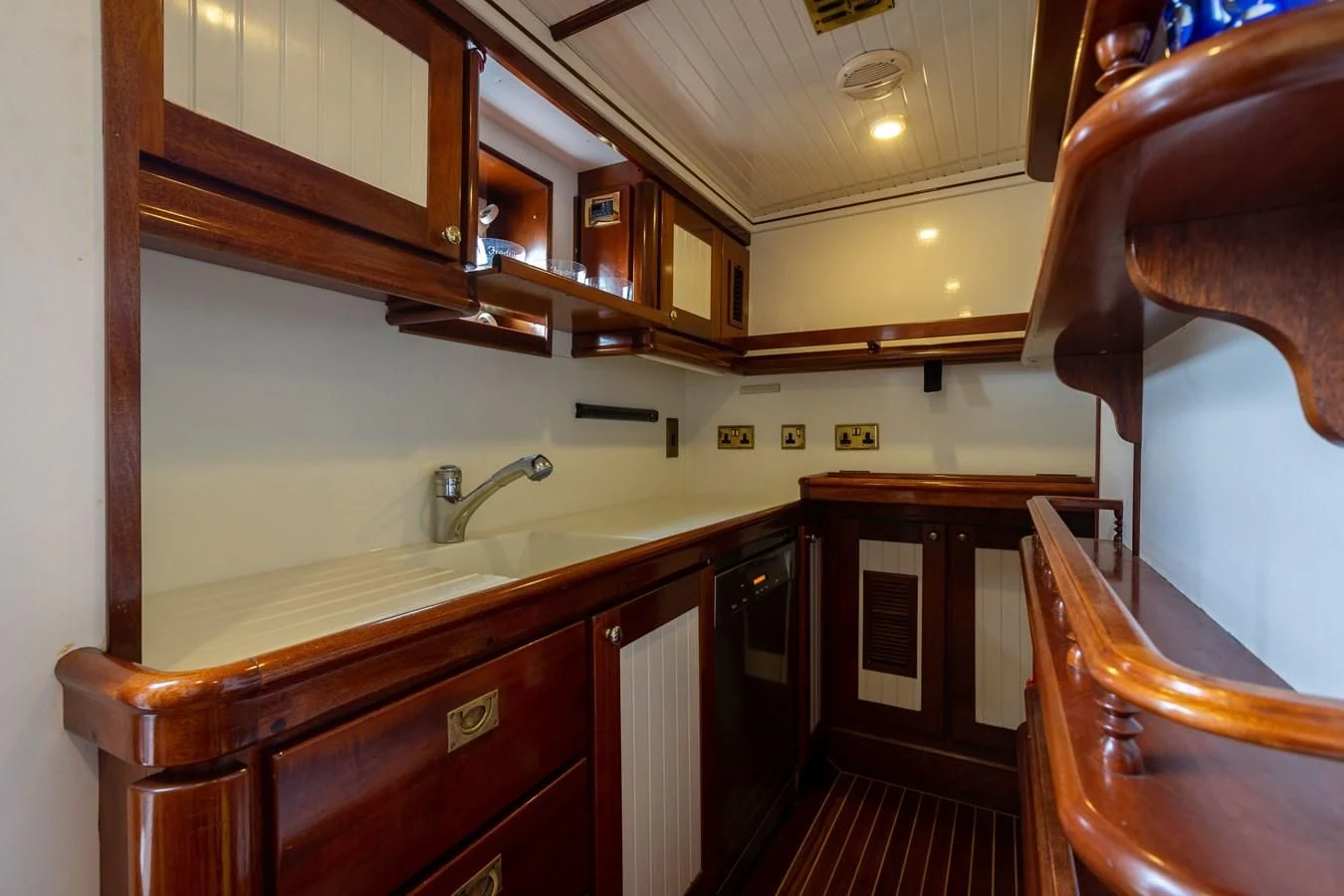 a kitchen with wooden cabinets aboard FREDRIKSTAD Yacht for Sale