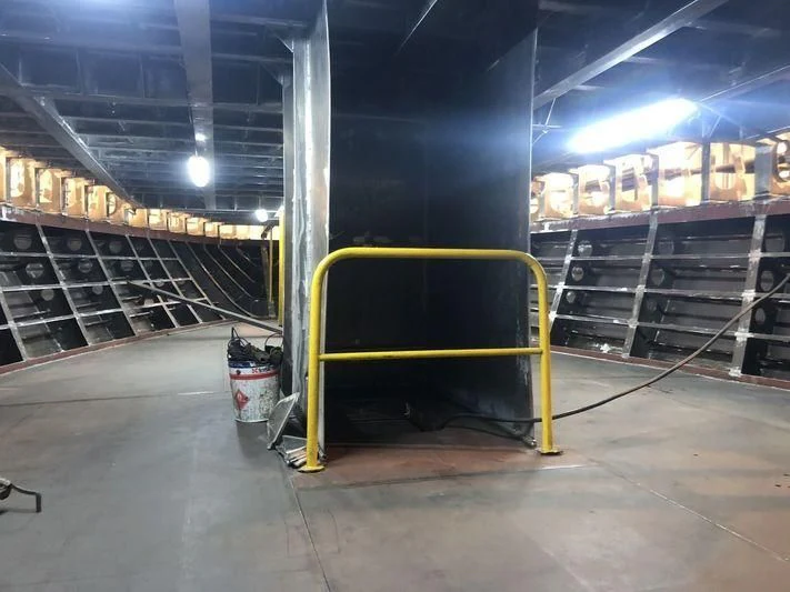 a warehouse with yellow bars aboard ROE Yacht for Sale