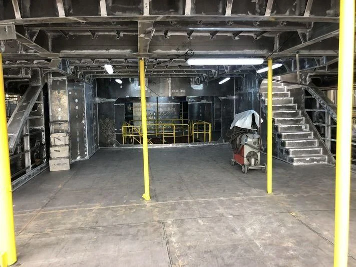 a warehouse with a few racks of equipment aboard ROE Yacht for Sale