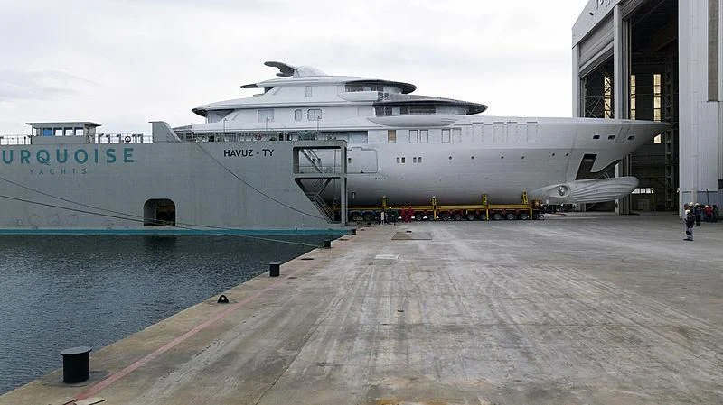 a large ship docked at a port aboard ROE Yacht for Sale