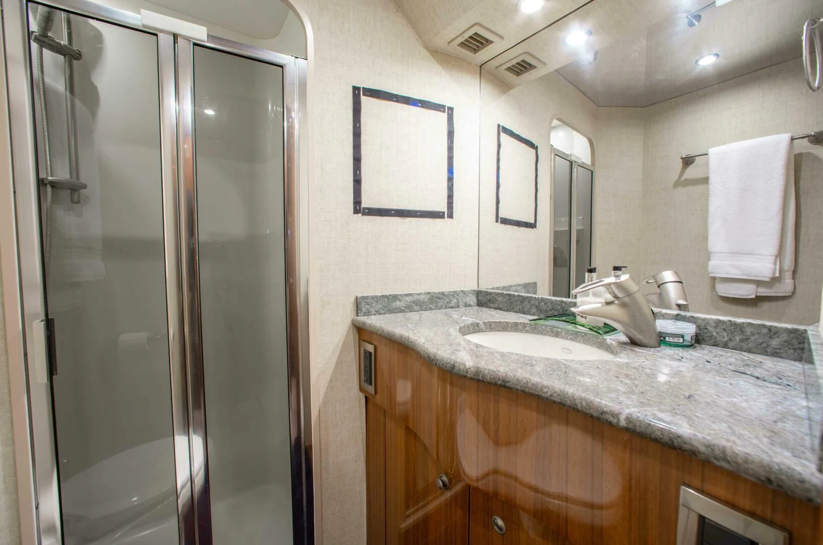 a bathroom with a glass shower aboard CURIOUS GEORGE Yacht for Sale