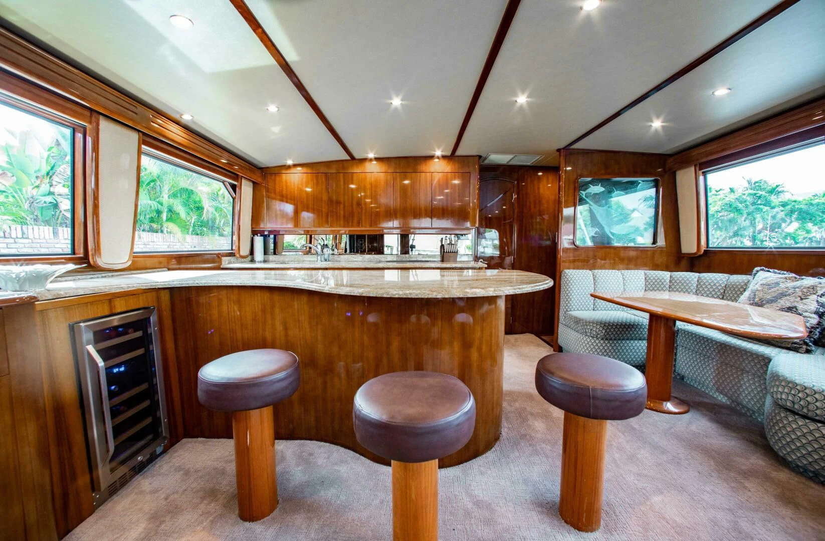 a kitchen with a table and stools aboard CURIOUS GEORGE Yacht for Sale