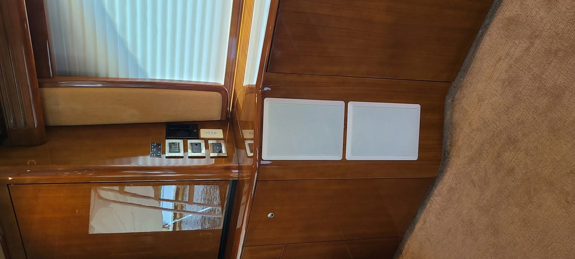 a wooden cabinet with a radio and a window aboard CURIOUS GEORGE Yacht for Sale