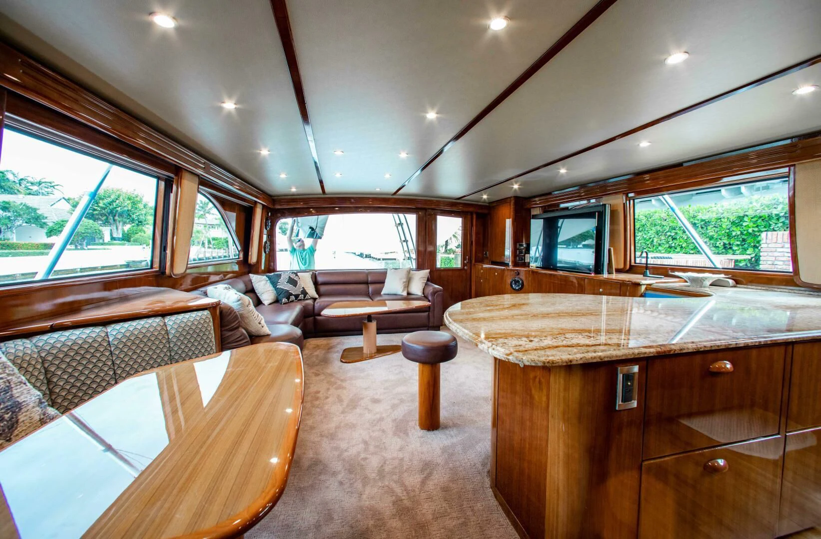 a large living room with wood furniture aboard CURIOUS GEORGE Yacht for Sale