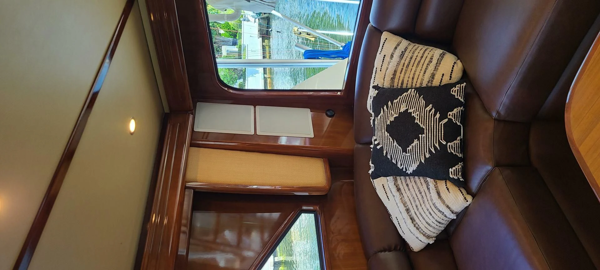 a seat with a seat and a window aboard CURIOUS GEORGE Yacht for Sale