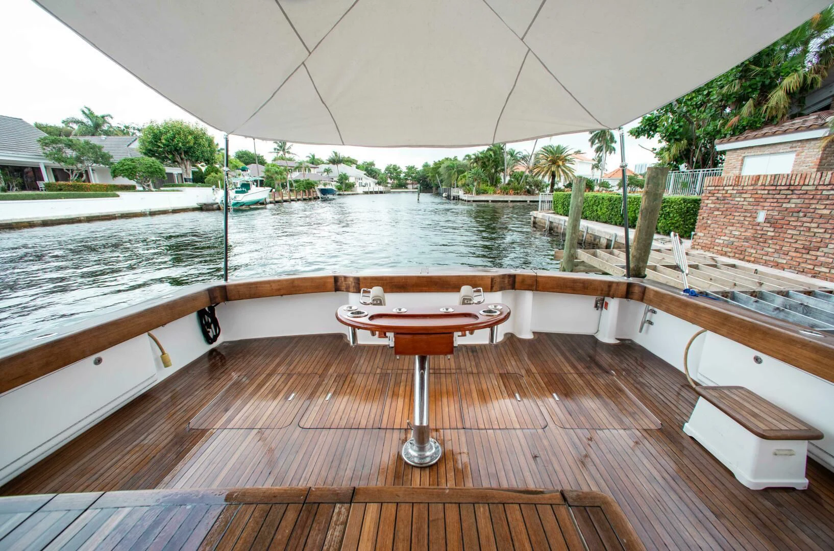 a deck with a table and chairs on it aboard CURIOUS GEORGE Yacht for Sale