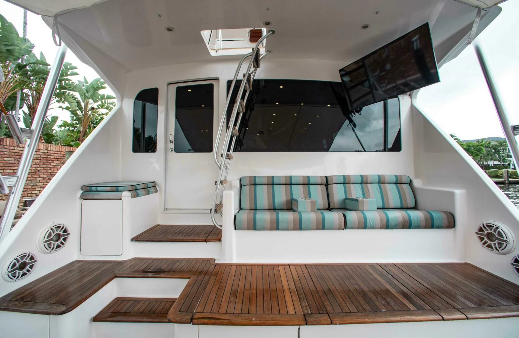 a deck with a couch and a pool table aboard CURIOUS GEORGE Yacht for Sale