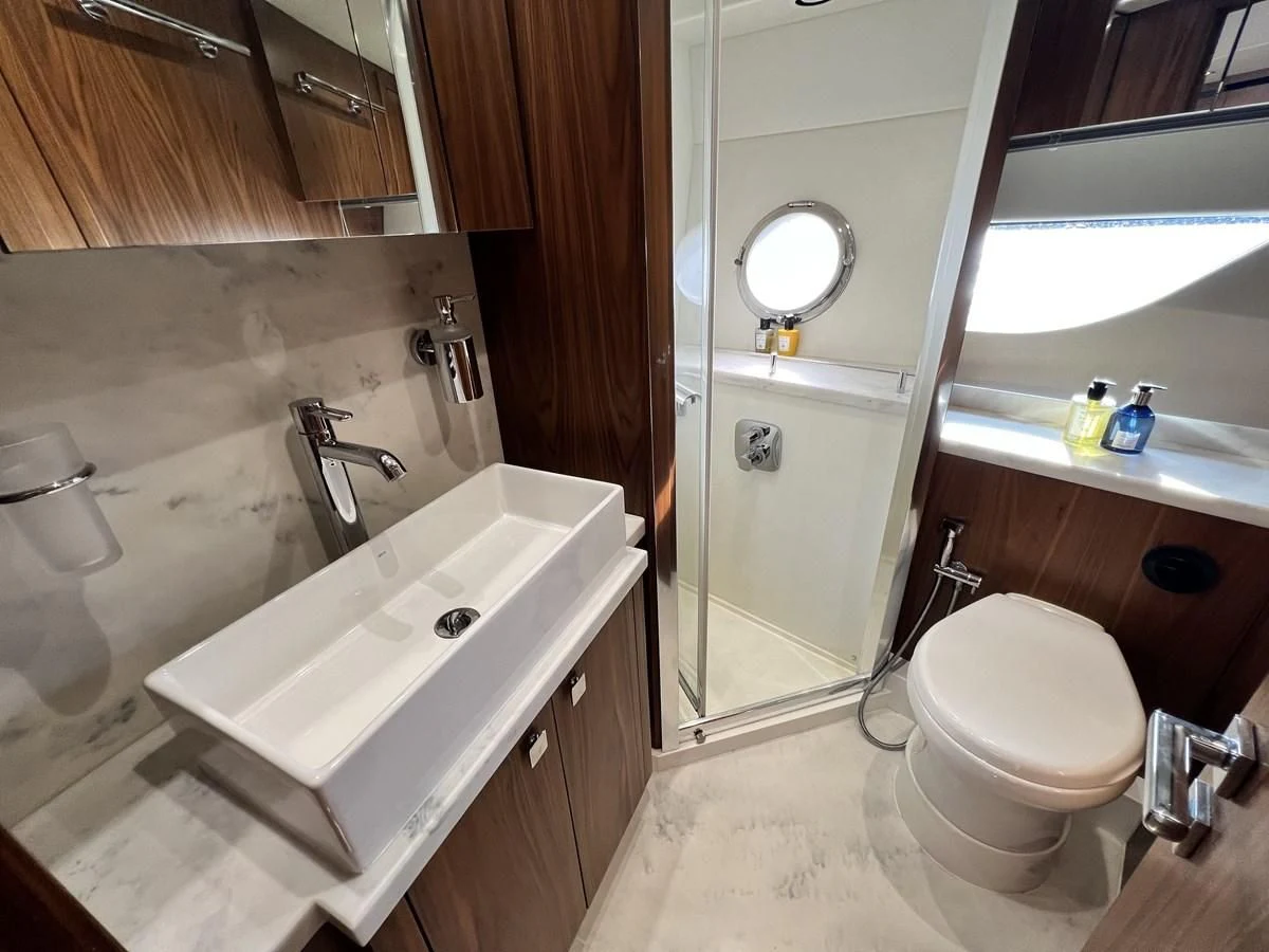 a bathroom with a sink toilet and a bathtub aboard SUNSEEKER PREDATOR 68 Yacht for Sale
