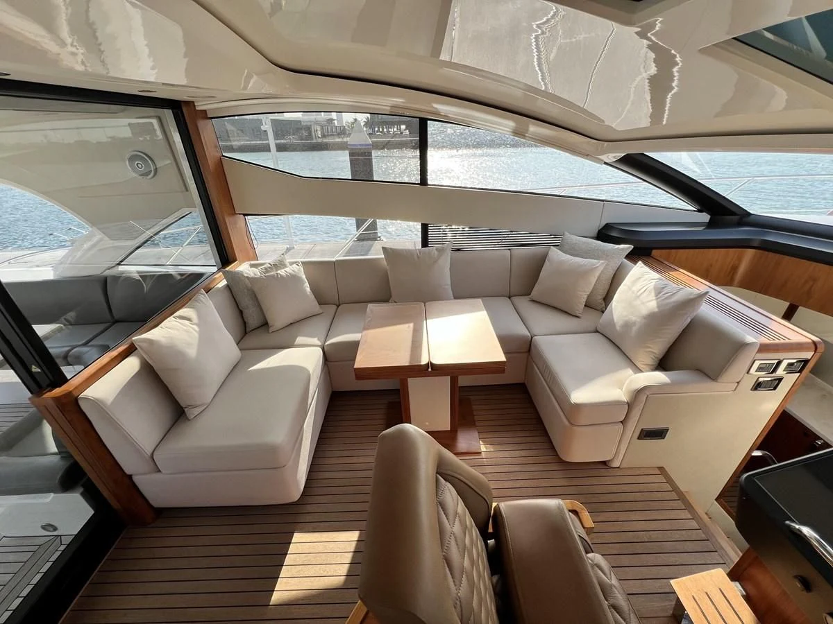 a room with a couch and a table and chairs aboard SUNSEEKER PREDATOR 68 Yacht for Sale
