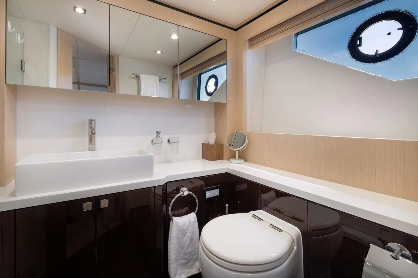 a bathroom with a sink toilet and a mirror aboard SUNSEEKER PREDATOR 68 Yacht for Sale