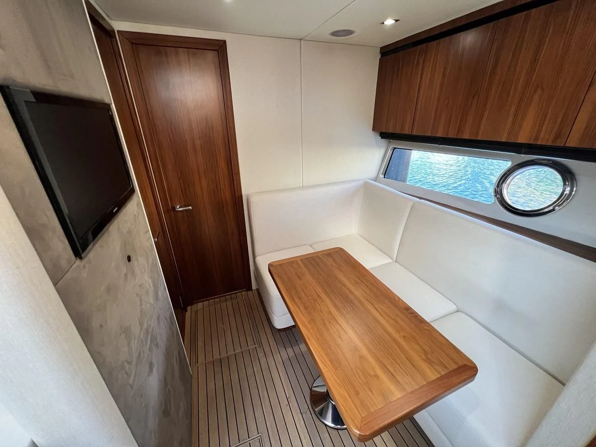 a room with a tv and a wood cabinet aboard SUNSEEKER PREDATOR 68 Yacht for Sale
