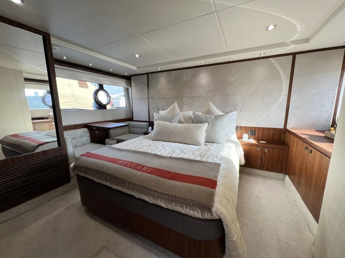 a room with a bed and a window aboard SUNSEEKER PREDATOR 68 Yacht for Sale