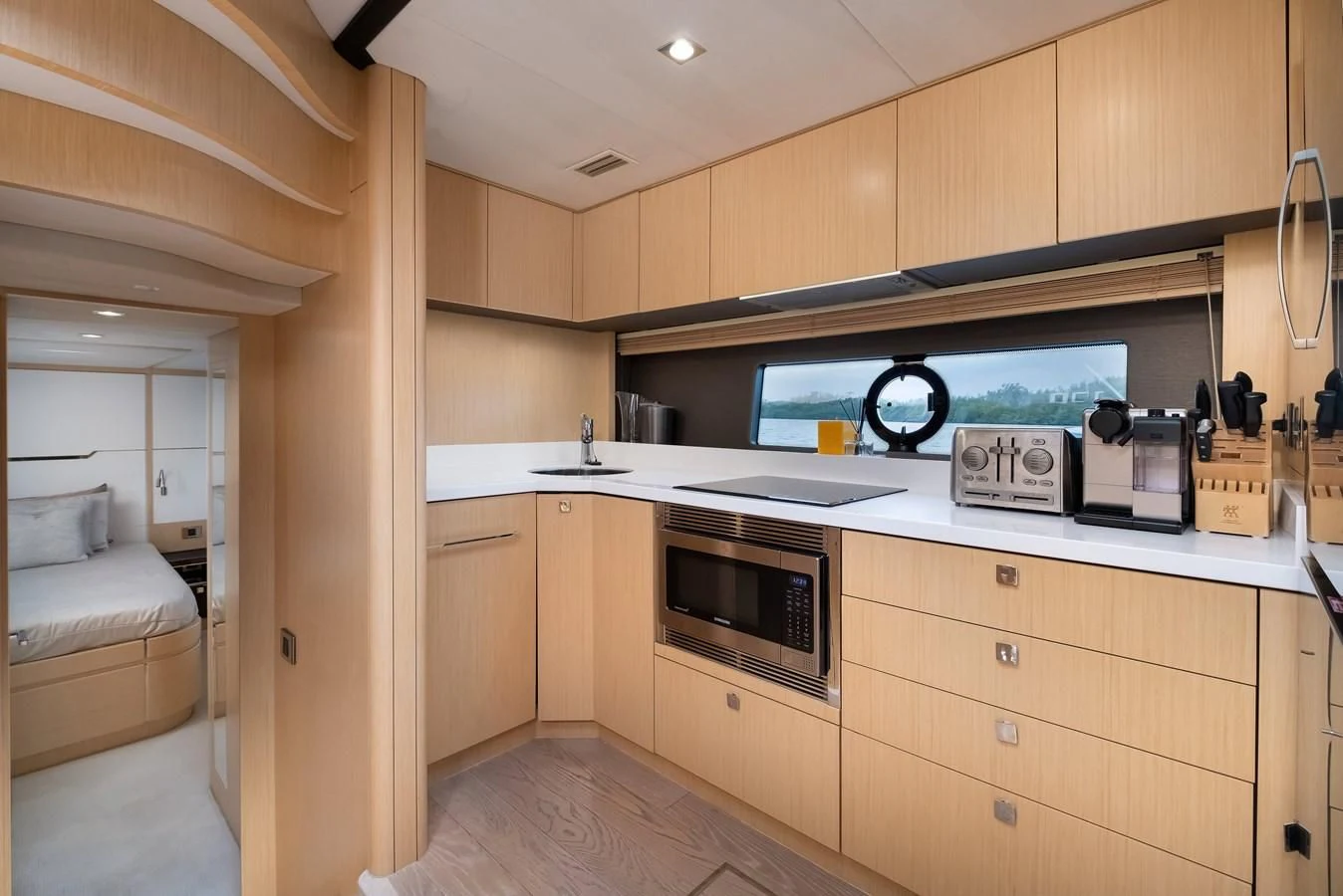 a kitchen with wooden cabinets aboard SUNSEEKER PREDATOR 68 Yacht for Sale