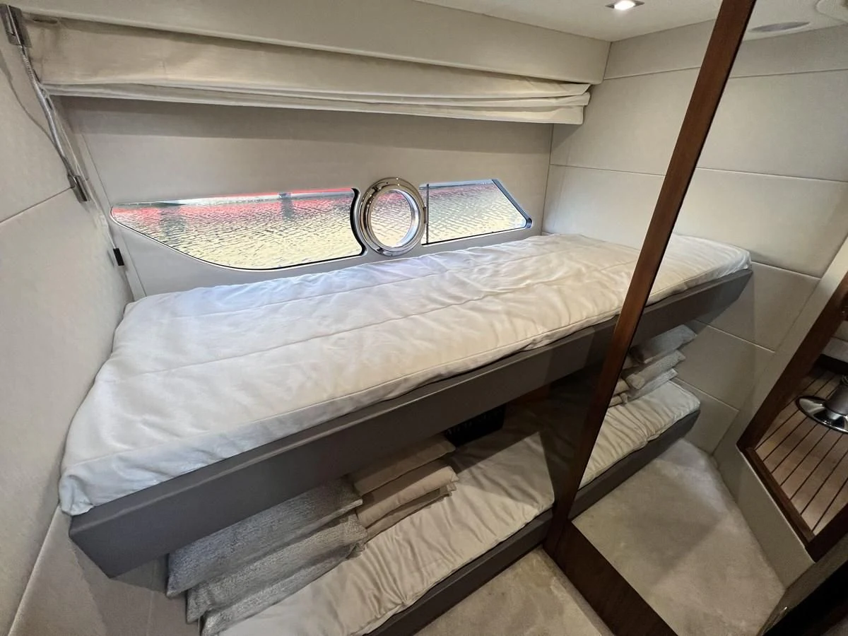 a bed with a white sheet aboard SUNSEEKER PREDATOR 68 Yacht for Sale