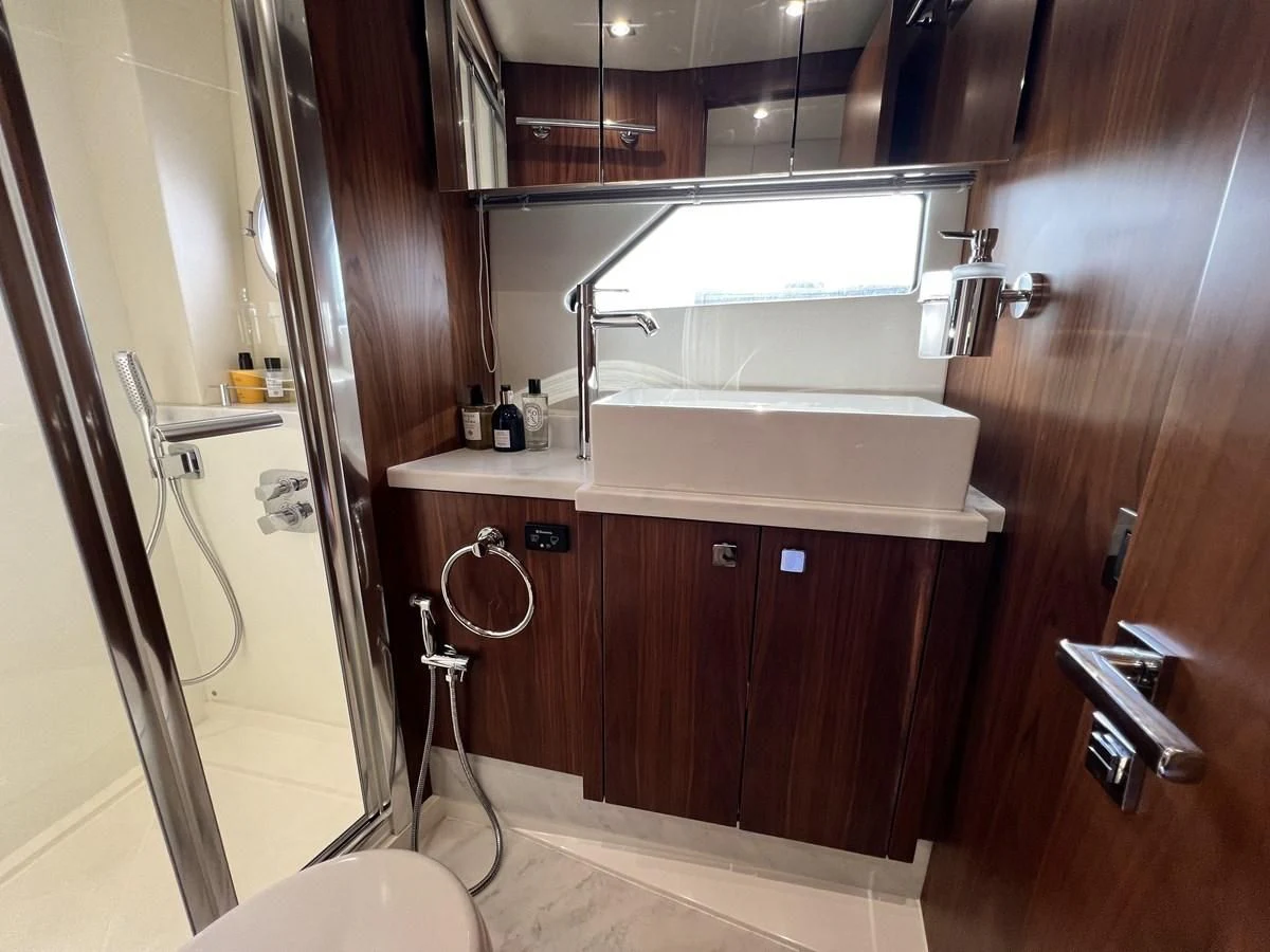 a bathroom with a sink and a mirror aboard SUNSEEKER PREDATOR 68 Yacht for Sale