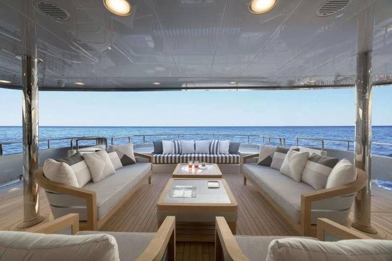 a room with a table and couches aboard DRAGOLUNA Yacht for Sale