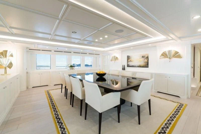 a large room with tables and chairs aboard DRAGOLUNA Yacht for Sale
