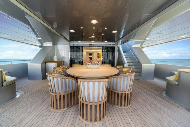 a room with a table and chairs aboard DRAGOLUNA Yacht for Sale
