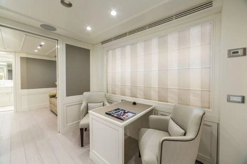 a living room with a large window aboard DRAGOLUNA Yacht for Sale