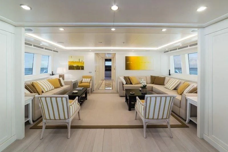 a living room with a couch and a table aboard DRAGOLUNA Yacht for Sale