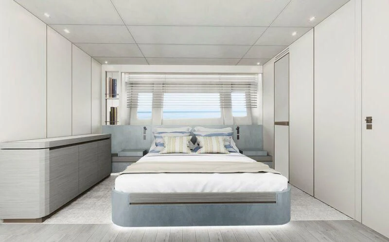 a white bedroom with a bed aboard NADA Yacht for Sale