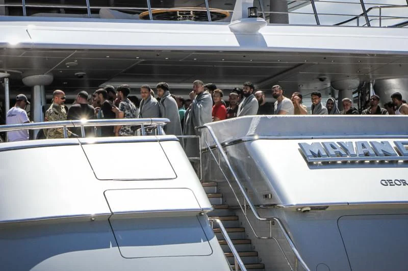 a group of people on a white escalator aboard MAYAN QUEEN IV Yacht for Sale