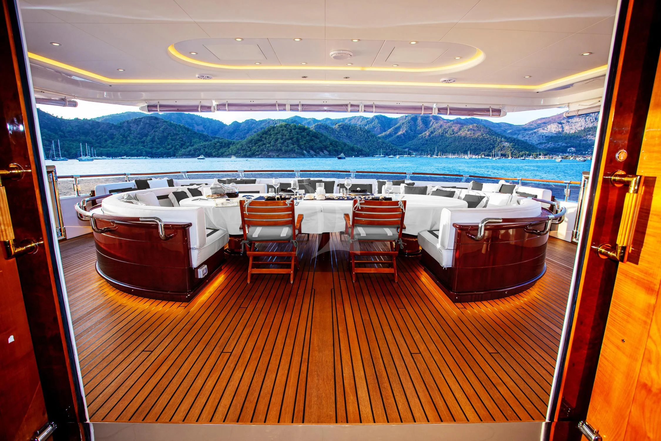 a room with a table and chairs aboard AQUA MARE Yacht for Sale