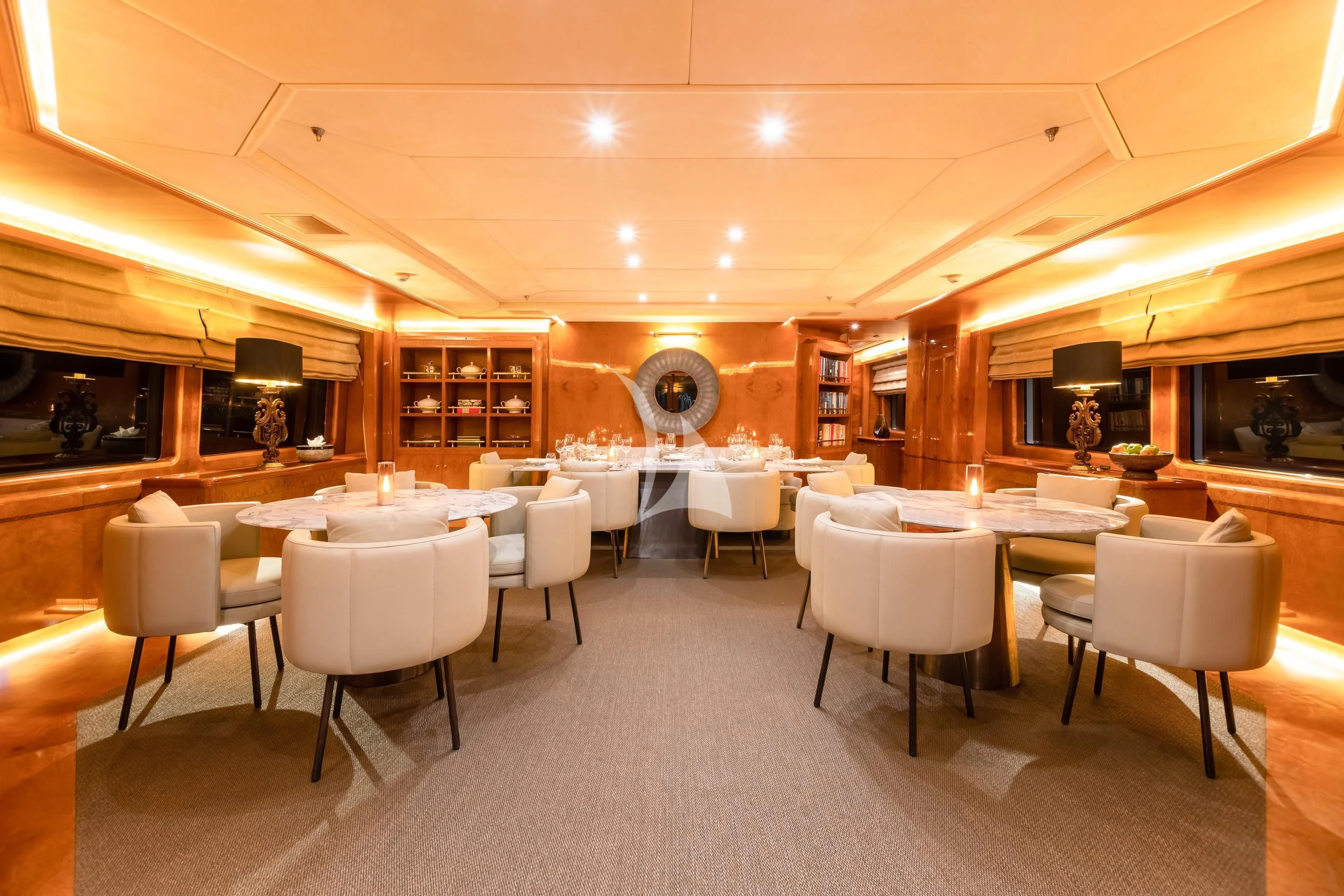 a room with tables and chairs aboard AQUA MARE Yacht for Sale