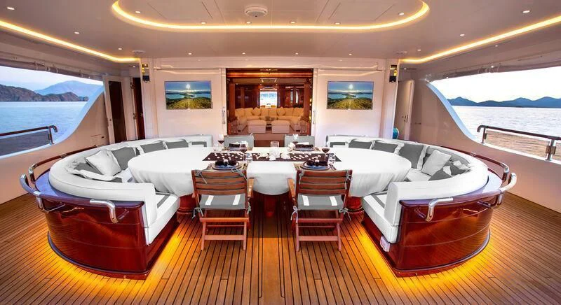 a room with a table and chairs aboard AQUA MARE Yacht for Sale