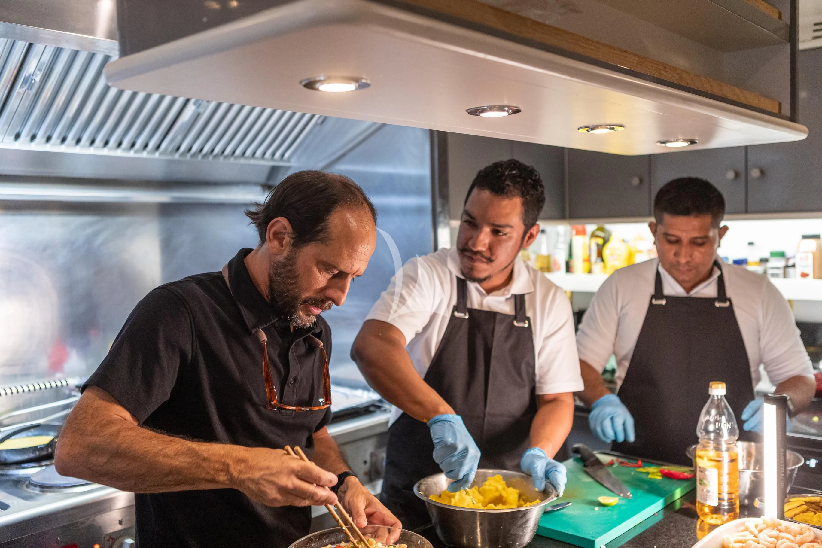 a group of men in a kitchen aboard AQUA MARE Yacht for Sale