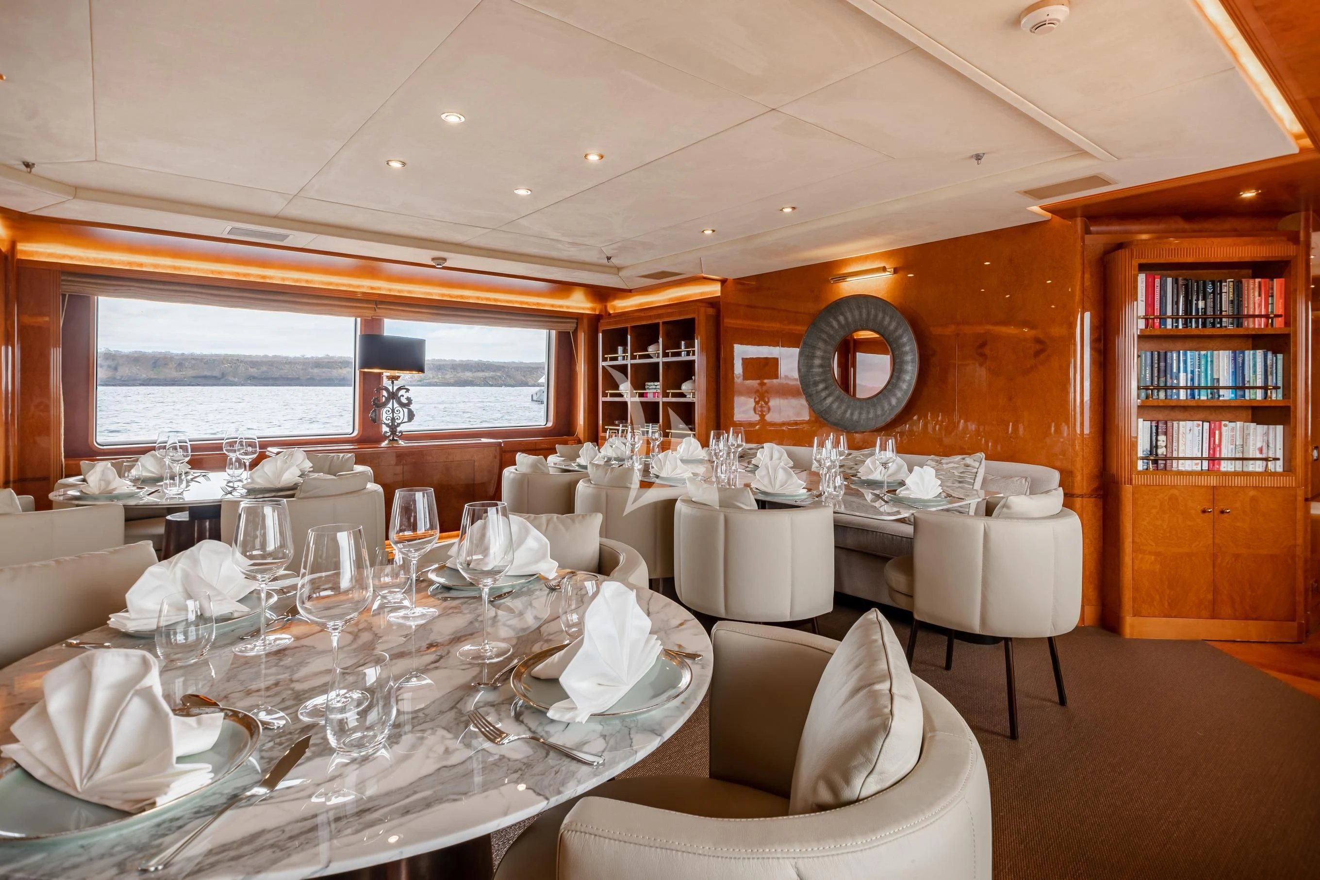a room with tables and chairs aboard AQUA MARE Yacht for Sale
