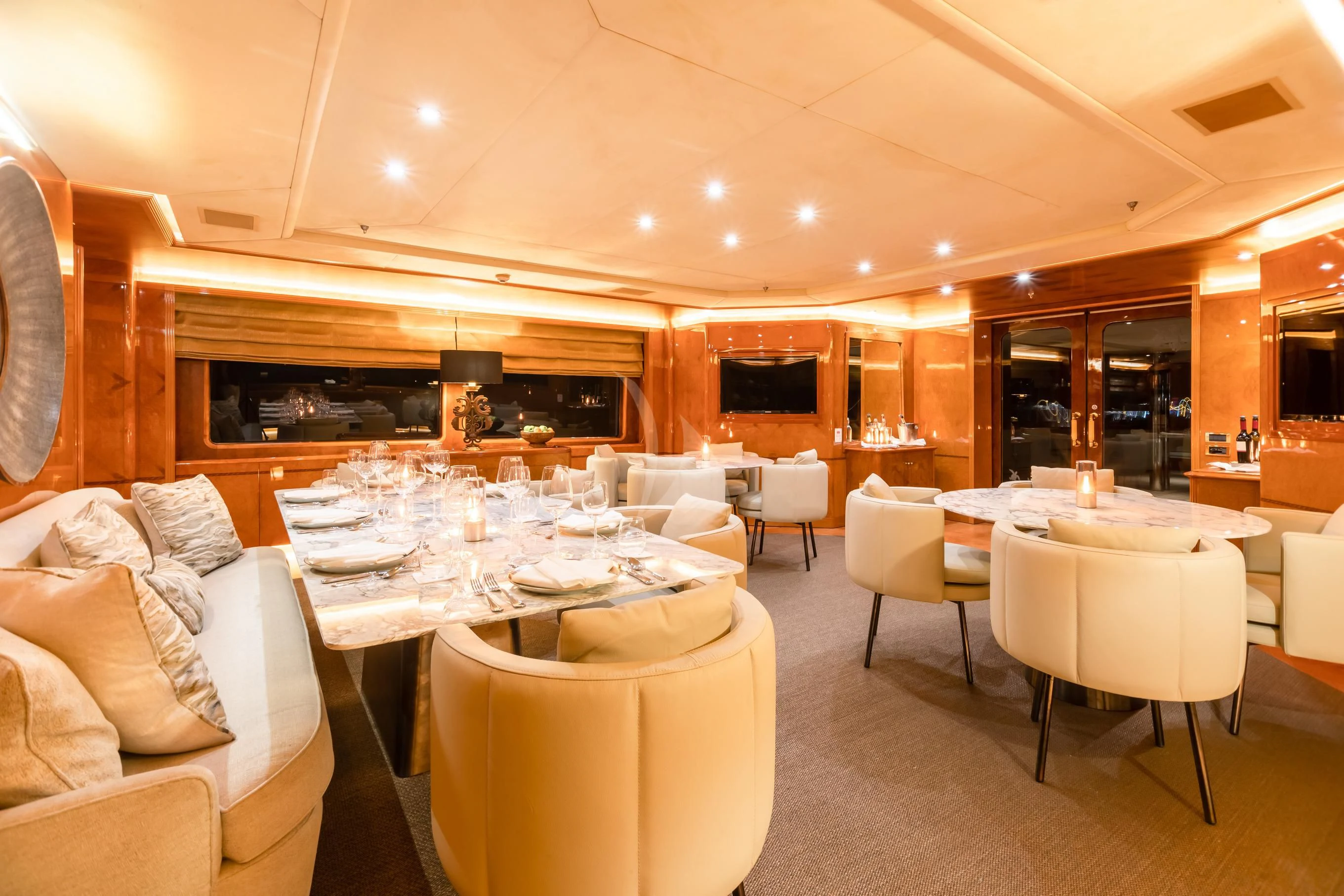 a room with tables and chairs aboard AQUA MARE Yacht for Sale