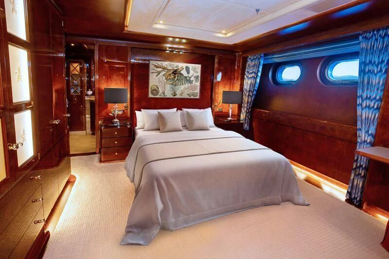 a bedroom with a bed and a desk aboard AQUA MARE Yacht for Sale