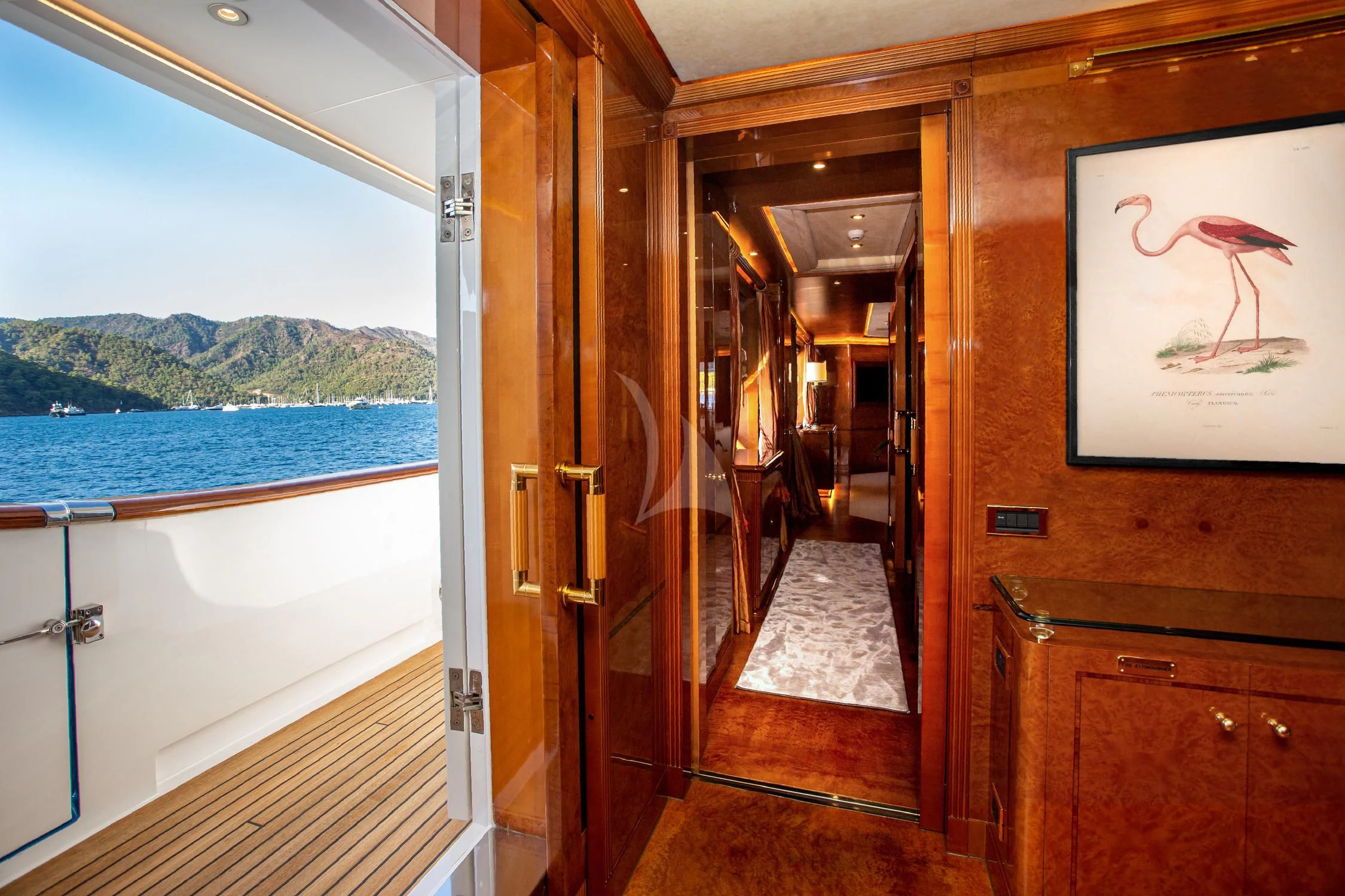 a room with a door and a painting on the wall aboard AQUA MARE Yacht for Sale