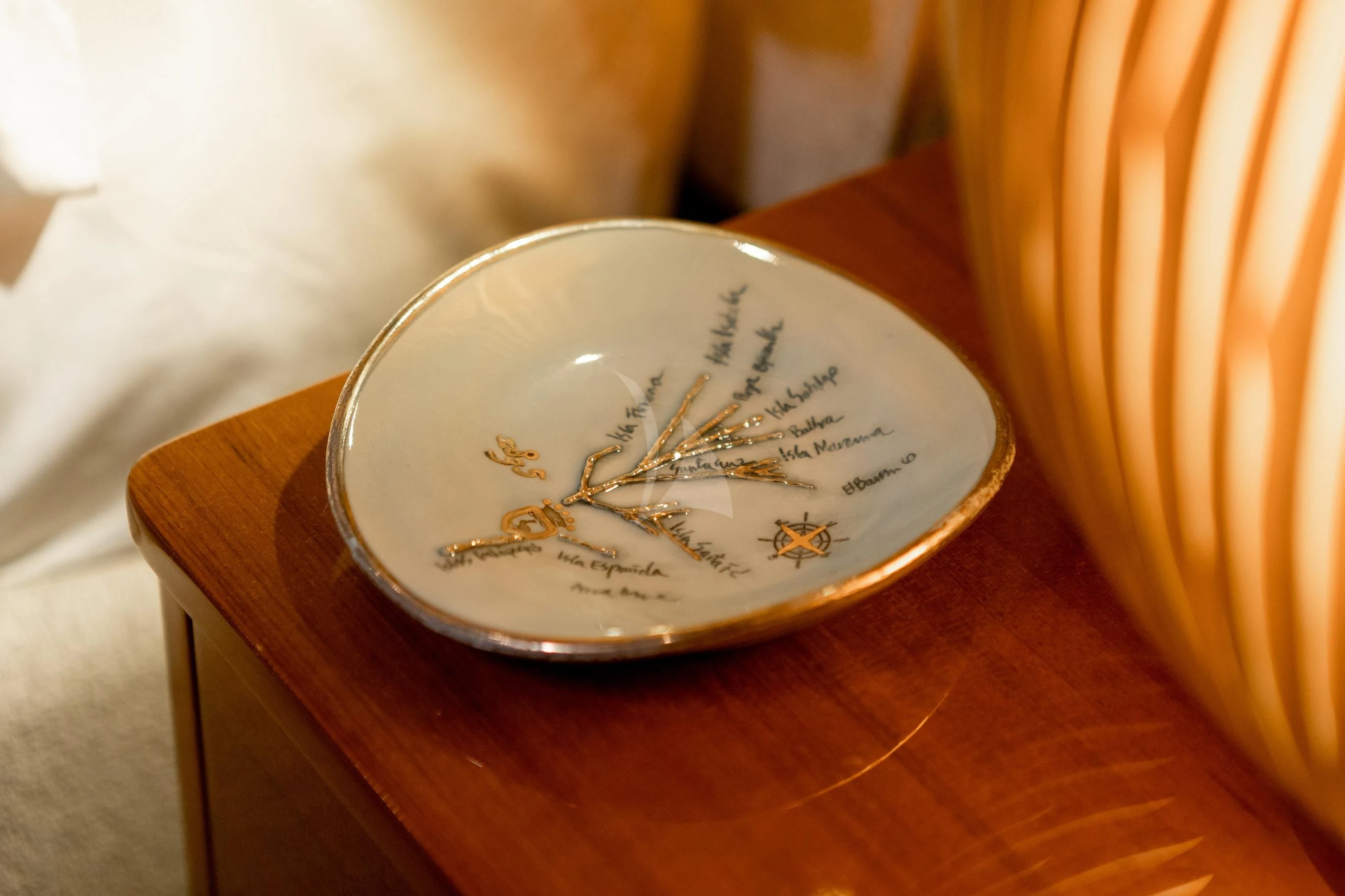 a round white object on a wooden surface aboard AQUA MARE Yacht for Sale