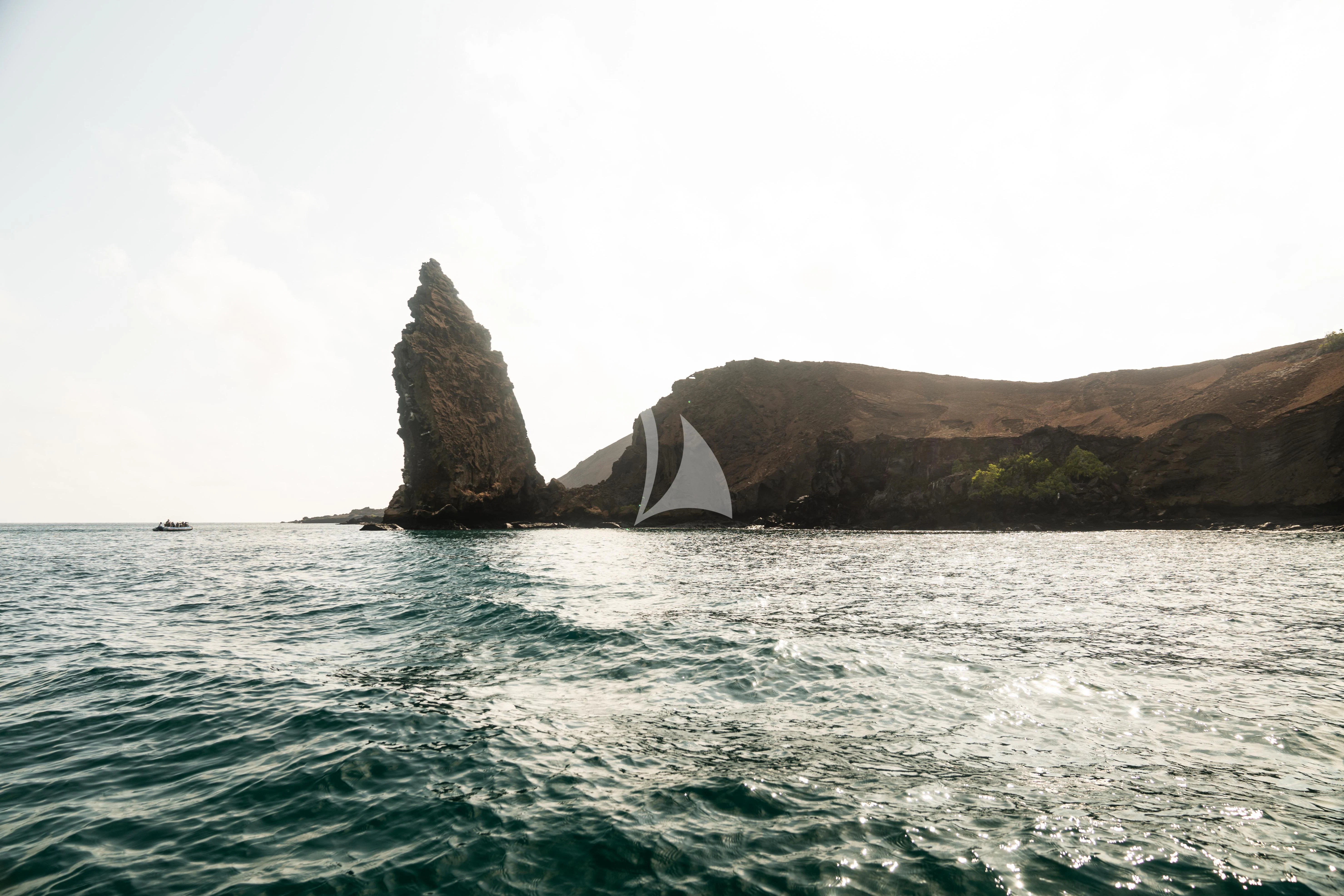 a body of water with rocks in the background aboard AQUA MARE Yacht for Sale