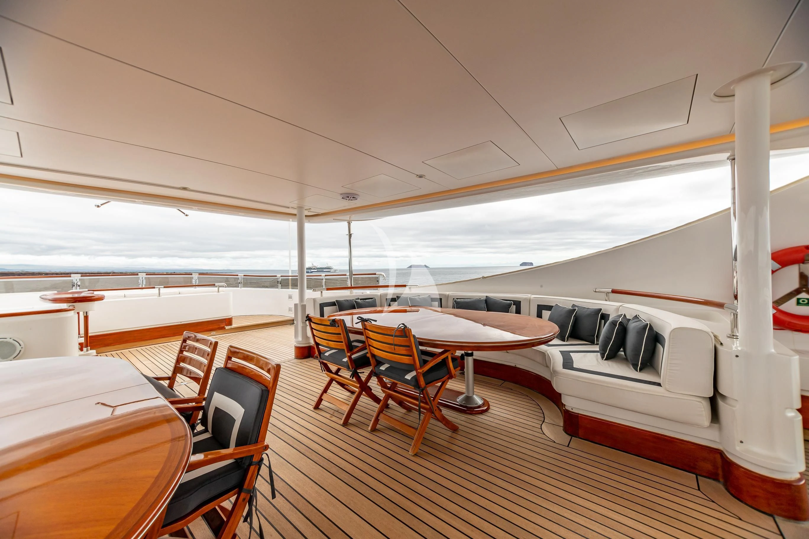 a room with a table and chairs aboard AQUA MARE Yacht for Sale