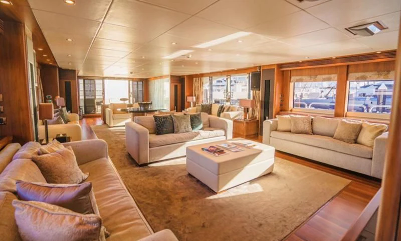 a living room with a couch and a coffee table aboard LUCIEN Yacht for Sale