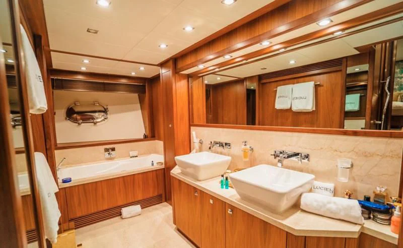 a bathroom with a sink and a mirror aboard LUCIEN Yacht for Sale
