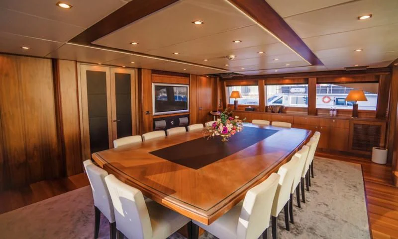 a conference room with a table and chairs aboard LUCIEN Yacht for Sale