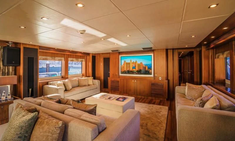 a living room with a large screen aboard LUCIEN Yacht for Sale
