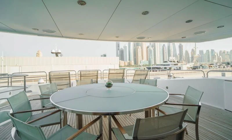 a room with tables and chairs aboard LUCIEN Yacht for Sale