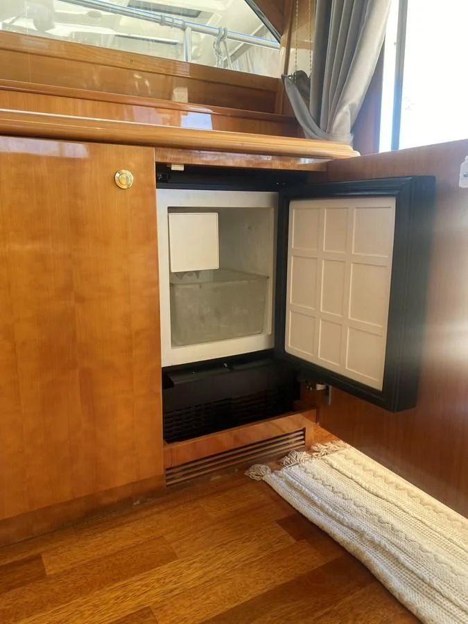 a wooden cabinet with a mirror aboard AMADEUS Yacht for Sale