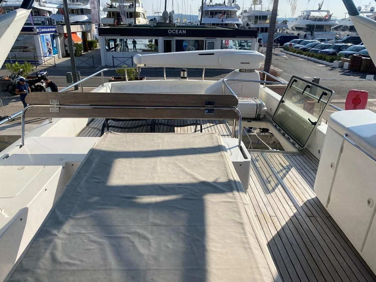 a deck with a railing and boats in the background aboard AMADEUS Yacht for Sale