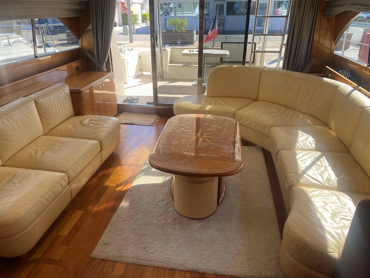 a living room with a couch and a coffee table aboard AMADEUS Yacht for Sale