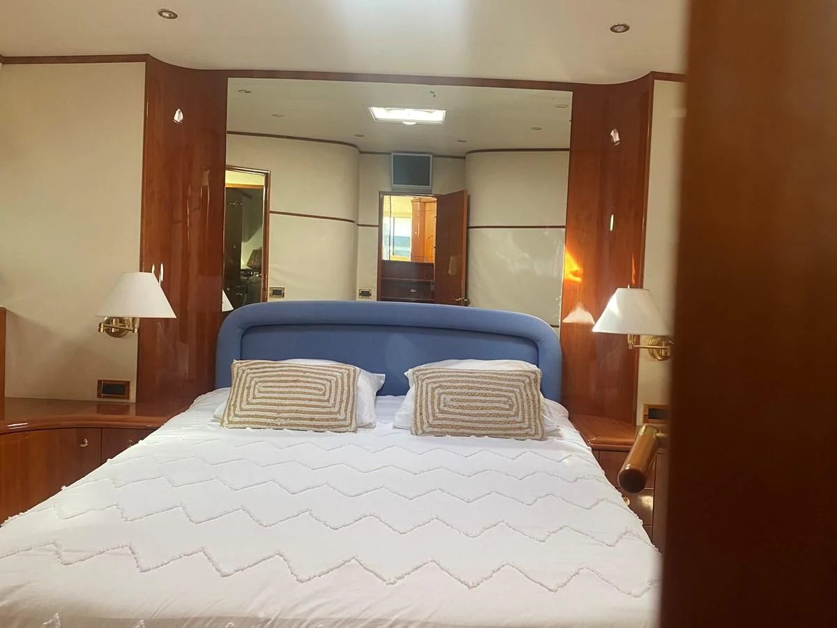 a bed with a white sheet aboard AMADEUS Yacht for Sale